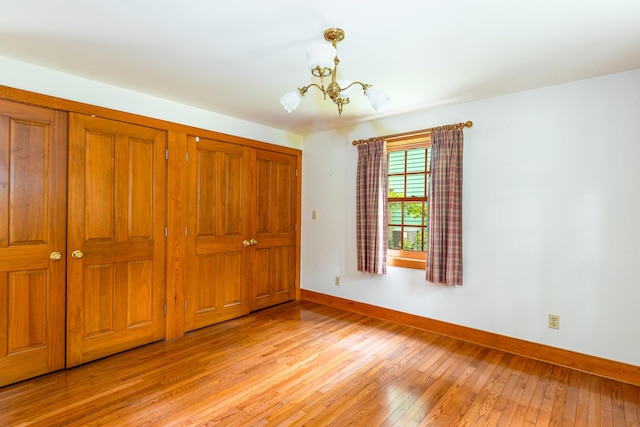 244 S Division St, Galena, IL 61036 - unfurnished bedroom with a chandelier and light wood-type flooring
