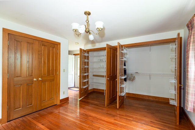 244 S Division St, Galena, IL 61036 - unfurnished bedroom featuring light wood-style floors and a chandelier