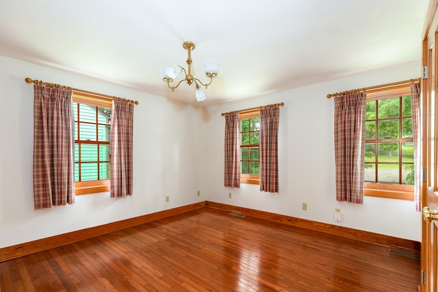 244 S Division St, Galena, IL 61036 - unfurnished room featuring a chandelier and hardwood / wood-style floors