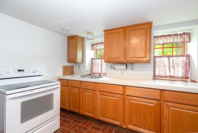 244 S Division St, Galena, IL 61036 - kitchen with electric range, healthy amount of natural light, light countertops, and brick patterned floors