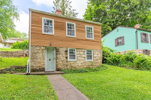 244 S Division St, Galena, IL 61036 - colonial-style house with a front lawn, a chimney, and stone siding
