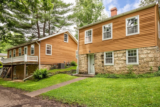 244 S Division St, Galena, IL 61036 - back of property with a chimney, stairs, a yard, a wooden deck, and stone siding