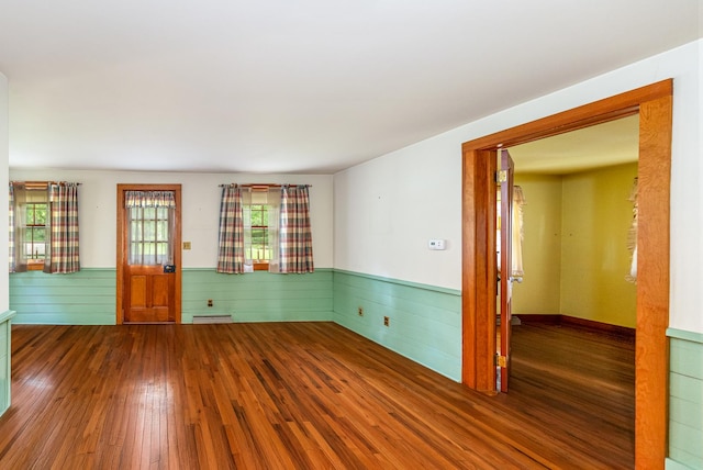 244 S Division St, Galena, IL 61036 - empty room featuring a wainscoted wall, wood-type flooring, and wood walls