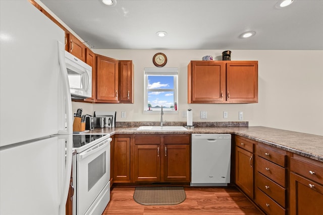 209A Evergreen St, Gifford, IL 61847 - kitchen featuring white appliances, brown cabinets, light wood-style flooring, recessed lighting, and dark countertops