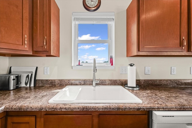 209A Evergreen St, Gifford, IL 61847 - detailed view of white dishwasher, brown cabinets, and dark countertops