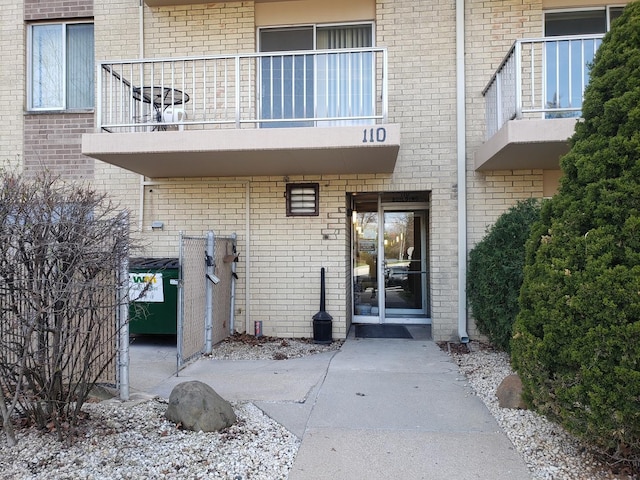 110 W Butterfield Rd Unit 405S, Elmhurst, IL 60126 - property entrance featuring a balcony and brick siding