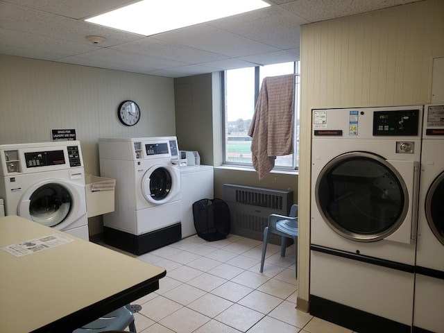 110 W Butterfield Rd Unit 405S, Elmhurst, IL 60126 - community laundry room featuring washer and clothes dryer, radiator, light tile patterned flooring, and wooden walls