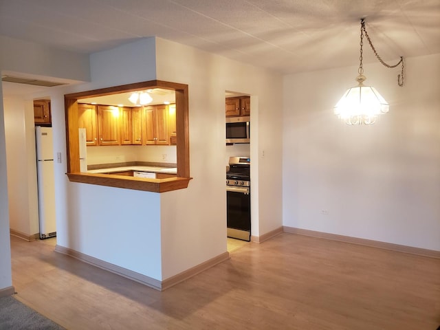 110 W Butterfield Rd Unit 405S, Elmhurst, IL 60126 - kitchen featuring appliances with stainless steel finishes, light wood-type flooring, decorative light fixtures, brown cabinetry, and a chandelier