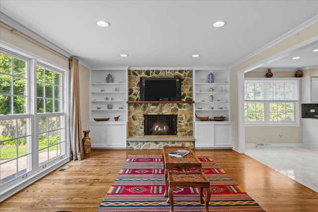 912 Morningside Dr, Lake Forest, IL 60045 - living area with a stone fireplace, crown molding, light wood-type flooring, recessed lighting, and built in shelves