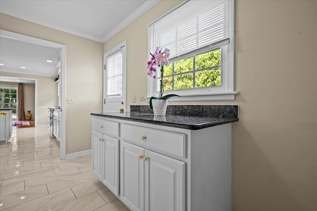 912 Morningside Dr, Lake Forest, IL 60045 - kitchen with light marble finish floors, white cabinetry, and crown molding