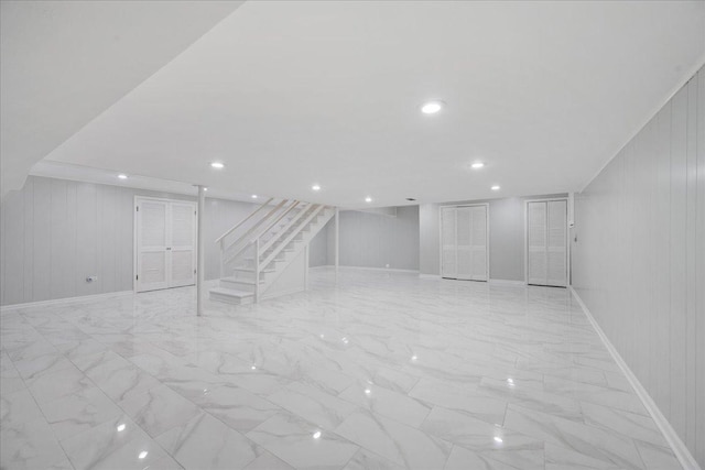 912 Morningside Dr, Lake Forest, IL 60045 - finished below grade area with stairway, light marble finish flooring, and wood walls