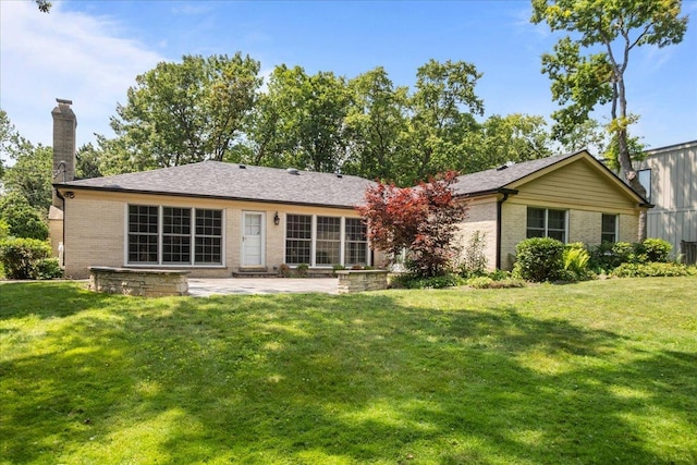 912 Morningside Dr, Lake Forest, IL 60045 - back of house featuring brick siding, a patio area, a lawn, and a chimney