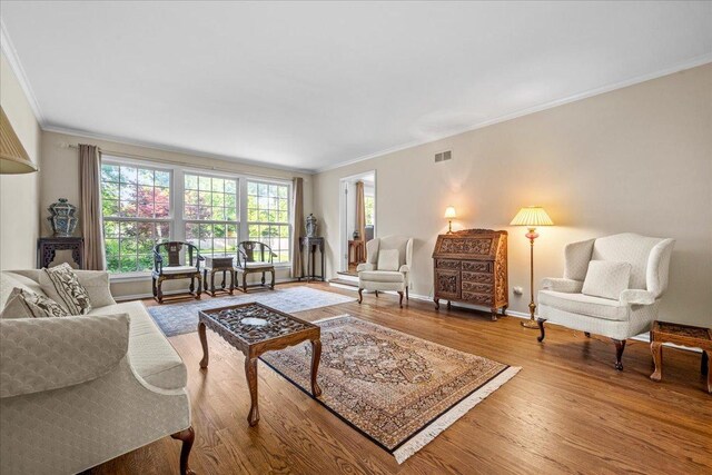912 Morningside Dr, Lake Forest, IL 60045 - living area with wood finished floors, ornamental molding, and healthy amount of natural light