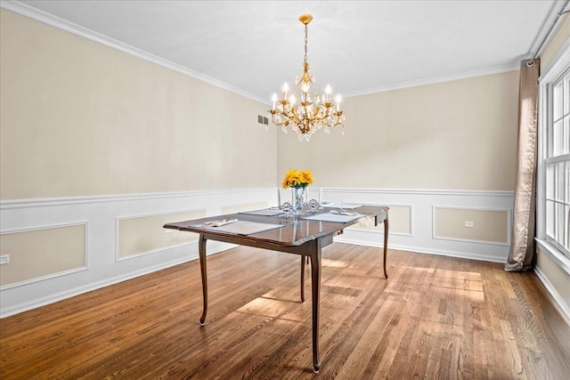 912 Morningside Dr, Lake Forest, IL 60045 - dining area with wood finished floors, a chandelier, ornamental molding, a wainscoted wall, and a decorative wall