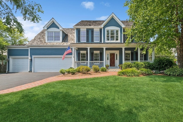 590 Oxford Ln, Lindenhurst, IL 60046 - colonial-style house with a front yard, an attached garage, a porch, and driveway