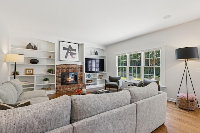 590 Oxford Ln, Lindenhurst, IL 60046 - living room featuring wood finished floors, a fireplace, and built in features
