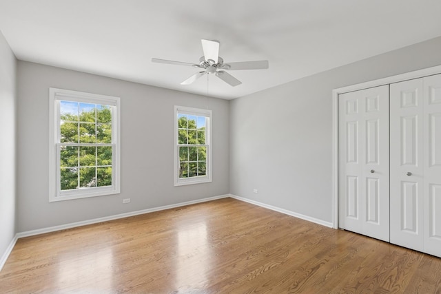 590 Oxford Ln, Lindenhurst, IL 60046 - unfurnished bedroom with wood finished floors, a closet, and a ceiling fan