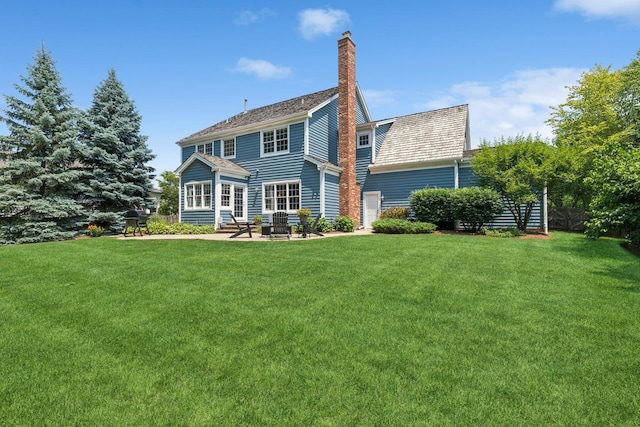 590 Oxford Ln, Lindenhurst, IL 60046 - back of property featuring a yard, a patio, and a chimney