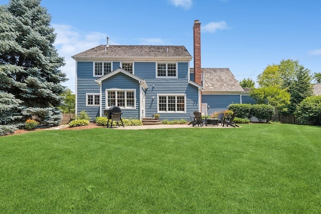 590 Oxford Ln, Lindenhurst, IL 60046 - rear view of house featuring a chimney and a patio