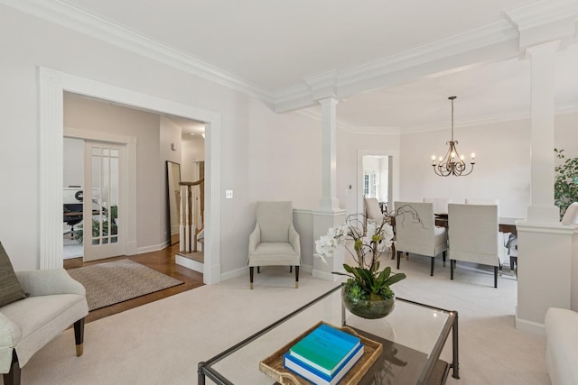 590 Oxford Ln, Lindenhurst, IL 60046 - carpeted living room featuring ornamental molding, decorative columns, and a chandelier