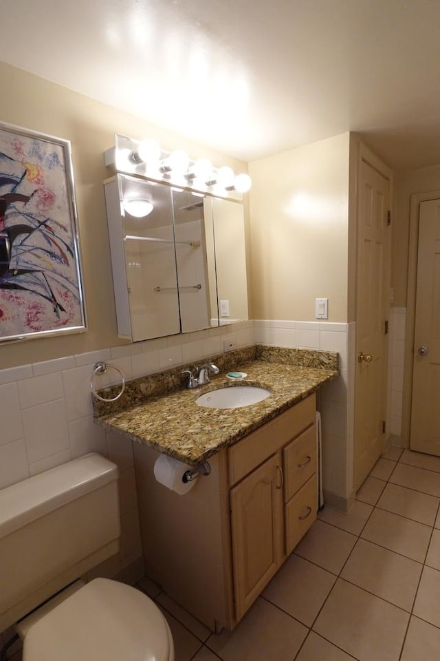 3533 N Natoma Ave, Chicago, IL 60634 - half bathroom featuring tile patterned flooring, tile walls, vanity, and wainscoting