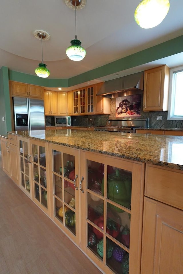 3533 N Natoma Ave, Chicago, IL 60634 - kitchen featuring wall chimney range hood, stainless steel appliances, decorative backsplash, and glass insert cabinets