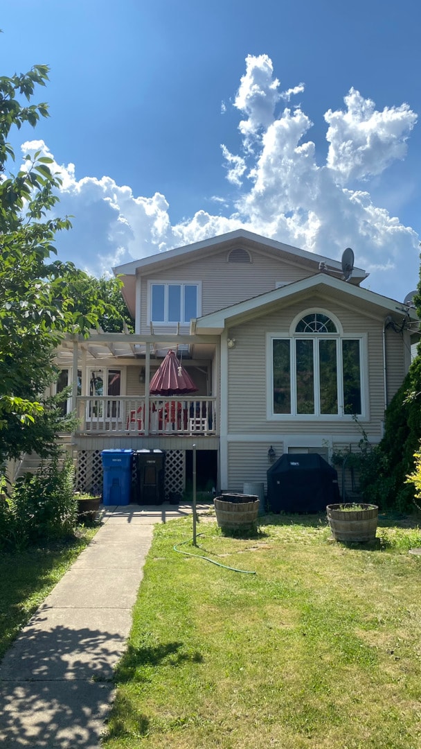 3533 N Natoma Ave, Chicago, IL 60634 - view of front of home featuring a front lawn and a wooden deck