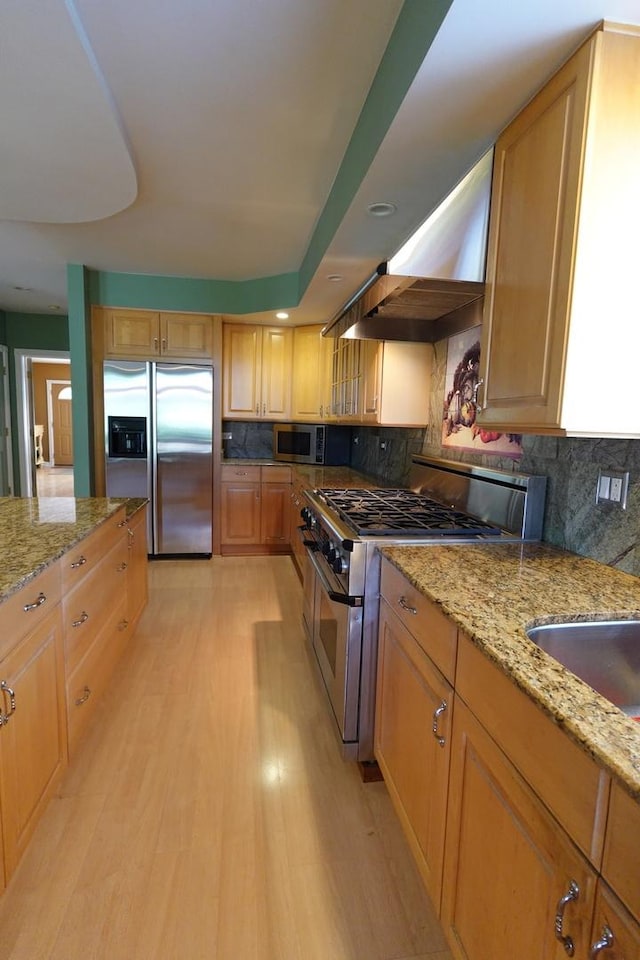 3533 N Natoma Ave, Chicago, IL 60634 - kitchen with appliances with stainless steel finishes, decorative backsplash, light stone counters, and light wood-type flooring