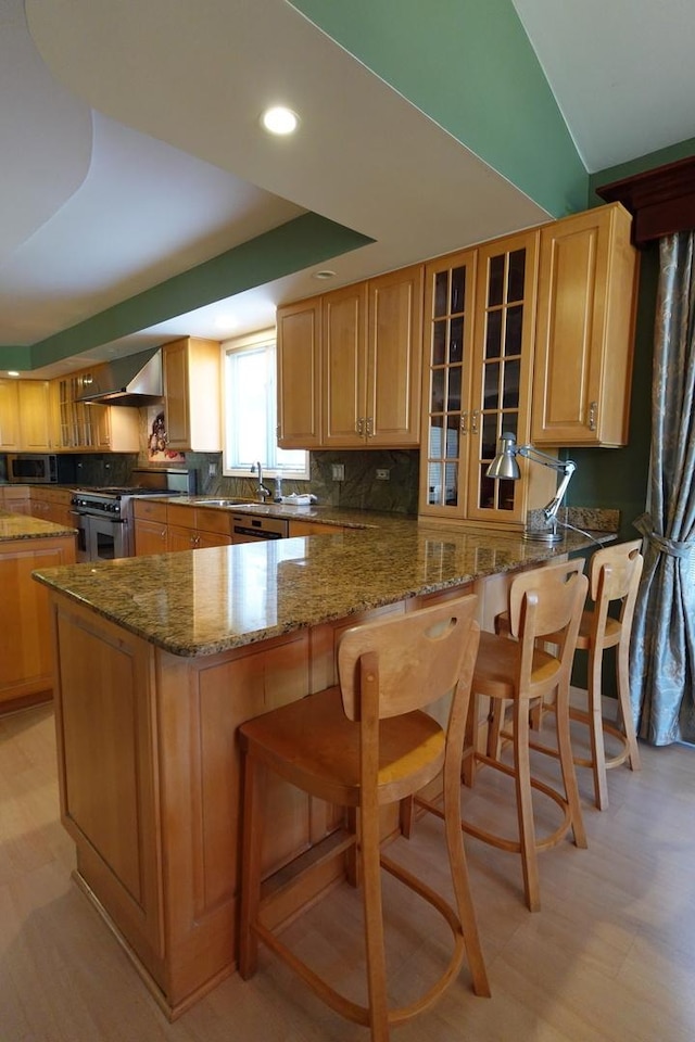 3533 N Natoma Ave, Chicago, IL 60634 - kitchen featuring high end range, wall chimney exhaust hood, glass insert cabinets, tasteful backsplash, and a breakfast bar