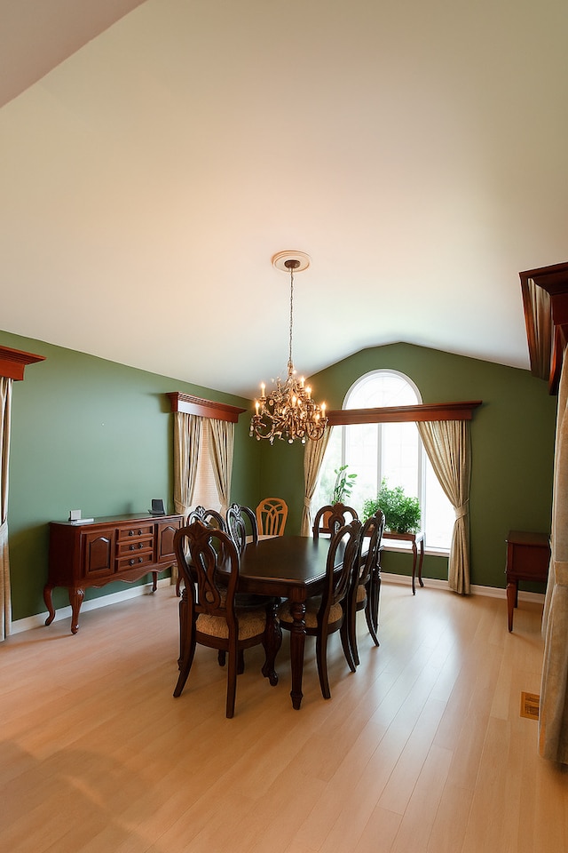 3533 N Natoma Ave, Chicago, IL 60634 - dining room featuring vaulted ceiling, a chandelier, and light wood finished floors