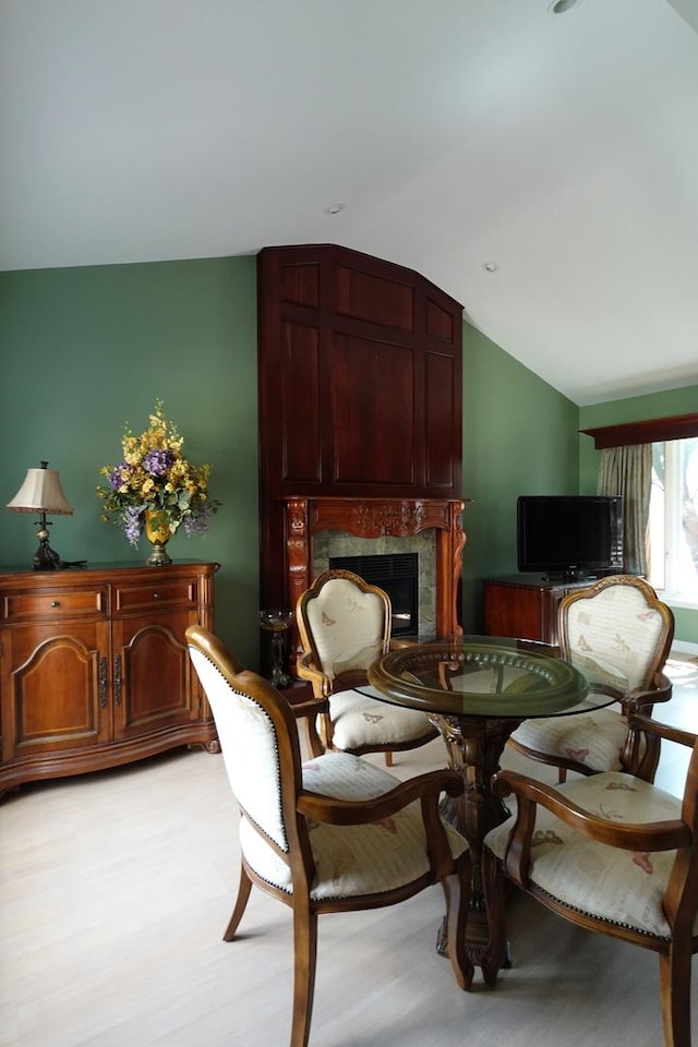 3533 N Natoma Ave, Chicago, IL 60634 - dining space featuring vaulted ceiling, a high end fireplace, and light wood-type flooring