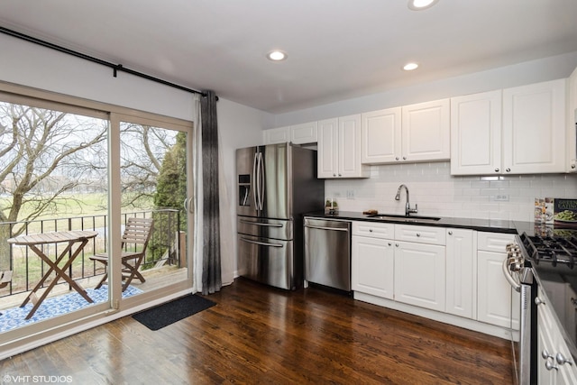 1487 N Clybourn Ave Unit B, Chicago, IL 60610 - kitchen with stainless steel appliances, dark countertops, backsplash, white cabinets, and recessed lighting