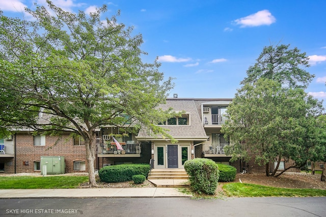 128 Bailey Rd Unit G, Naperville, IL 60565 - view of front of house featuring brick siding and a shingled roof