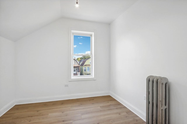 5048 W Superior St, Chicago, IL 60644 - bonus room with radiator heating unit, light wood finished floors, and vaulted ceiling