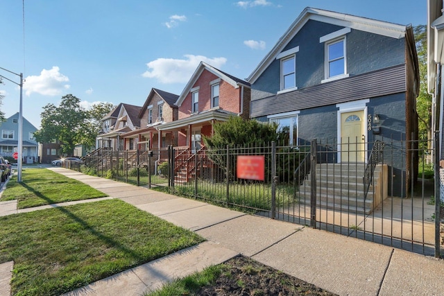 5048 W Superior St, Chicago, IL 60644 - view of front of property with a residential view, a fenced front yard, brick siding, and a gate