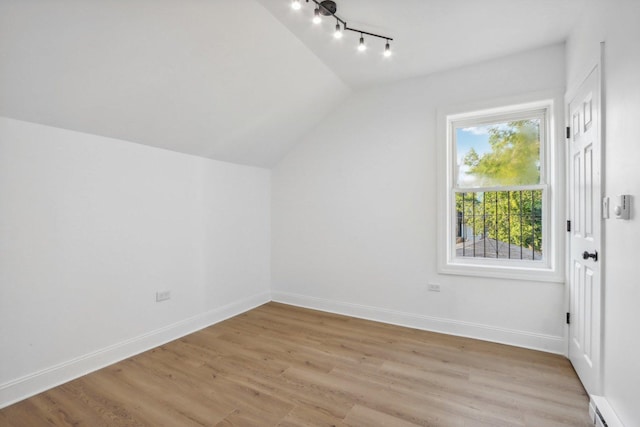 5048 W Superior St, Chicago, IL 60644 - bonus room with a baseboard radiator, lofted ceiling, and light wood-type flooring