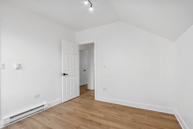 5048 W Superior St, Chicago, IL 60644 - bonus room featuring a baseboard radiator, lofted ceiling, and light wood-type flooring