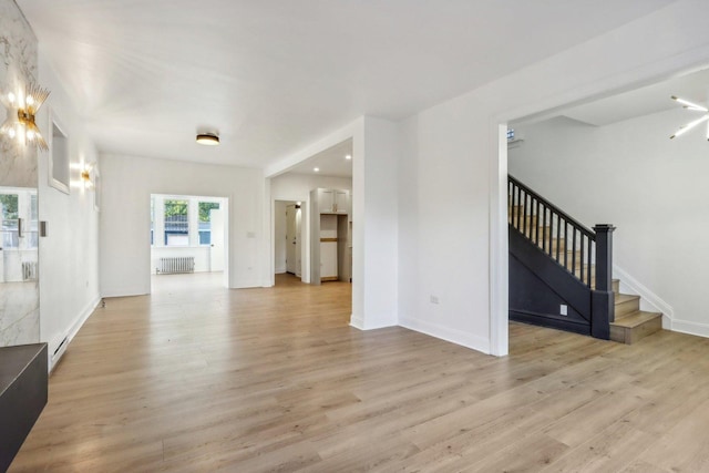 5048 W Superior St, Chicago, IL 60644 - unfurnished living room featuring radiator, stairs, and light wood-type flooring