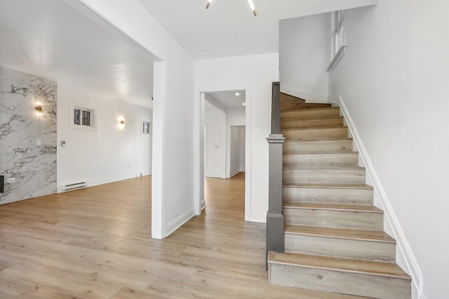 5048 W Superior St, Chicago, IL 60644 - stairway with a baseboard heating unit and wood finished floors