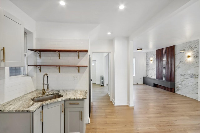 5048 W Superior St, Chicago, IL 60644 - kitchen featuring gray cabinetry, light wood-type flooring, light stone countertops, recessed lighting, and decorative backsplash