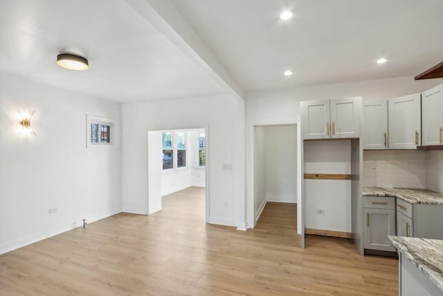 5048 W Superior St, Chicago, IL 60644 - kitchen featuring gray cabinets, recessed lighting, light wood-style flooring, light stone counters, and tasteful backsplash
