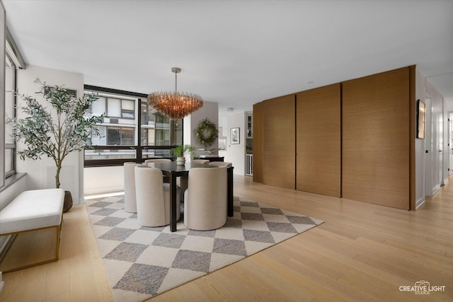 1410 N State Pkwy Unit 5B, Chicago, IL 60610 - dining space with a chandelier, light wood-type flooring, and a wall of windows