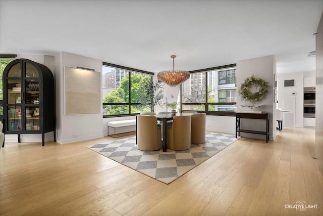 1410 N State Pkwy Unit 5B, Chicago, IL 60610 - dining area with a chandelier and light wood-type flooring