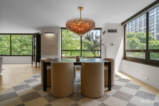 1410 N State Pkwy Unit 5B, Chicago, IL 60610 - dining room featuring a chandelier and light wood-type flooring