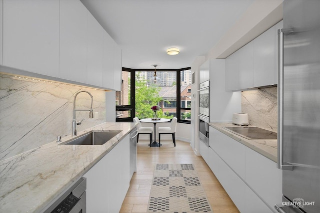 1410 N State Pkwy Unit 5B, Chicago, IL 60610 - kitchen featuring appliances with stainless steel finishes, modern cabinets, white cabinets, and backsplash