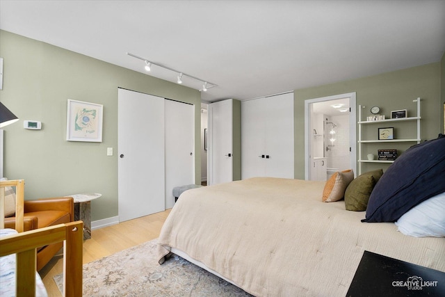 1410 N State Pkwy Unit 5B, Chicago, IL 60610 - bedroom featuring light wood-style floors, a closet, ensuite bath, and track lighting