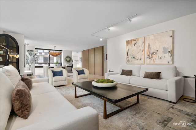 1410 N State Pkwy Unit 5B, Chicago, IL 60610 - living room featuring rail lighting and a chandelier