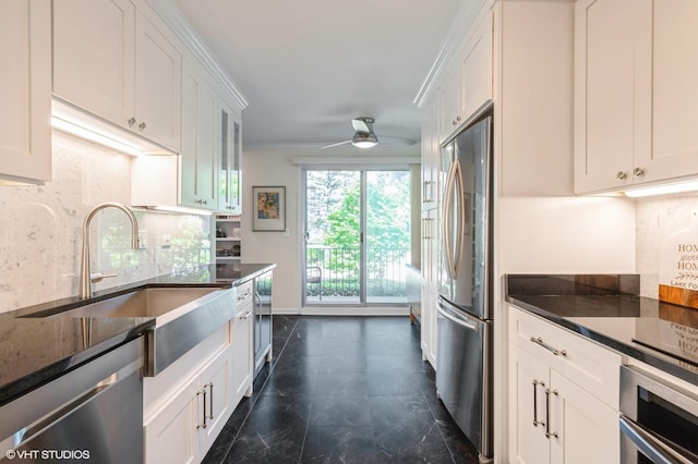 90 E Franklin Pl Unit 106, Lake Forest, IL 60045 - kitchen with appliances with stainless steel finishes, a ceiling fan, white cabinetry, decorative backsplash, and dark stone countertops