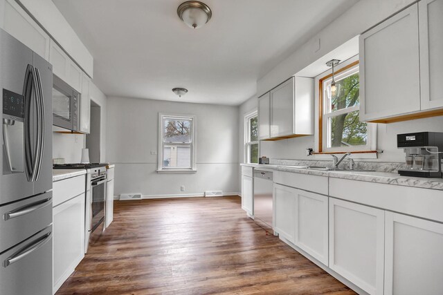 730 E 156th St, South Holland, IL 60473 - kitchen with stainless steel appliances, dark wood-style flooring, and white cabinetry