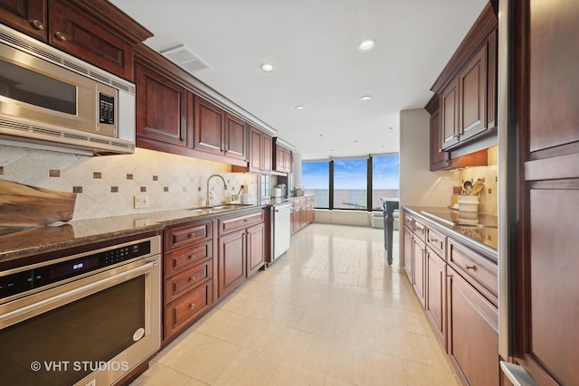 505 N Lake Shore Dr Unit 2110-11, Chicago, IL 60611 - kitchen with appliances with stainless steel finishes, backsplash, recessed lighting, and a wall of windows
